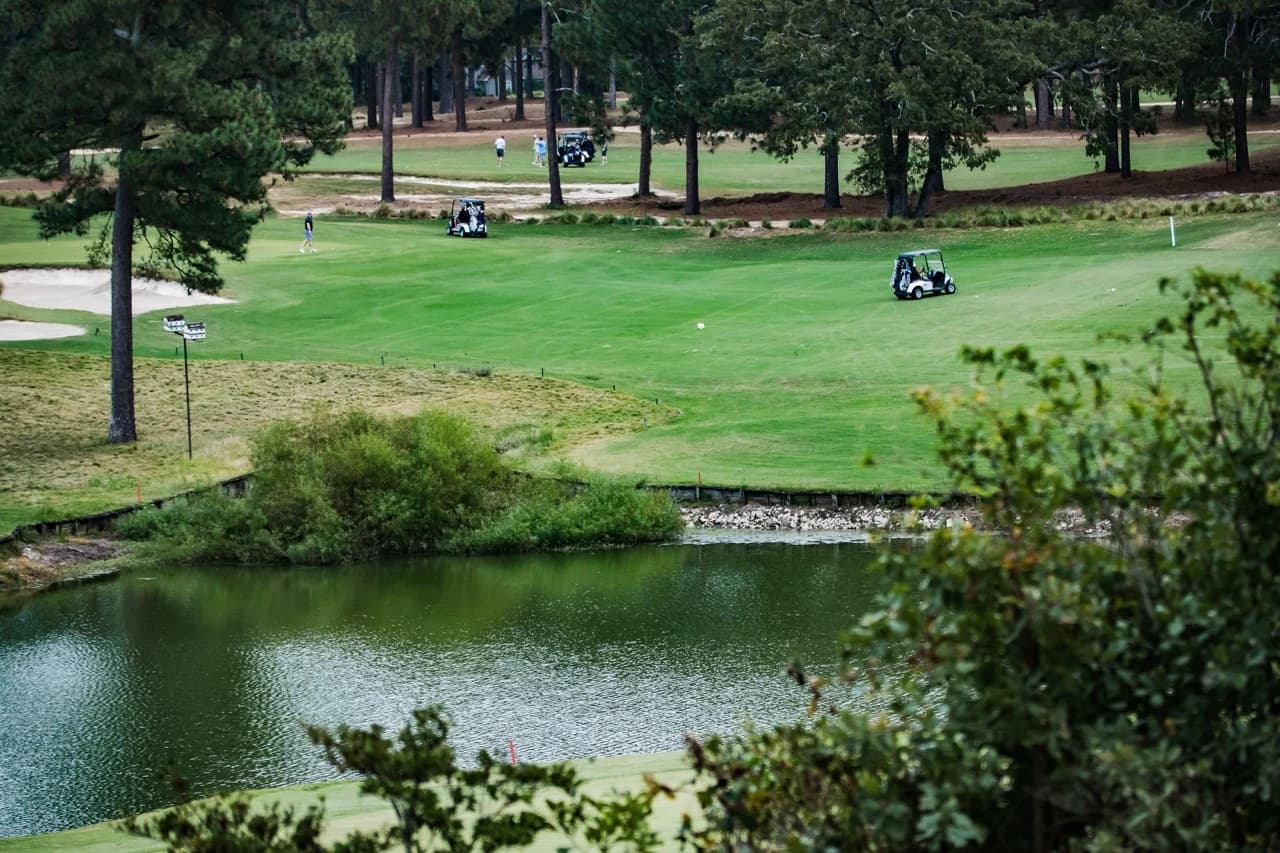 The fairways, pines, and pond at Hyland Golf Course during our 2026 inaugural tournament